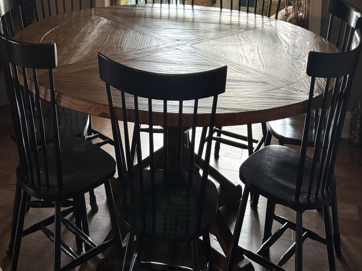 Tabatha's round wooden dining table in warm natural light